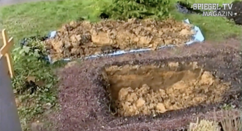 Tristan’s grandmother found the half-dug grave, with soil piled on a tarpaulin. Photo: Police video via SPIEGEL TV.