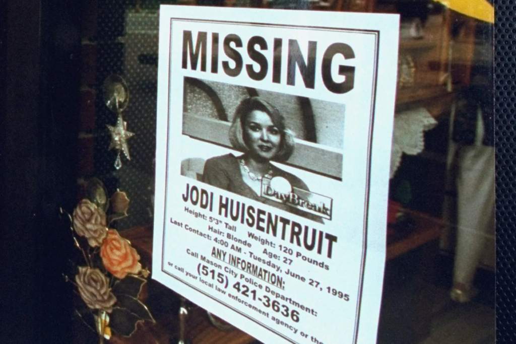 A missing person flyer for Jodi Huisentruit displayed in a Mason City storefront window days after her disappearance in June 1995.