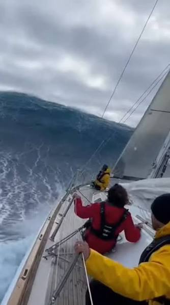 A rogue wave towers over a sailing crew in the Southern Ocean — the same conditions that rolled the Rose-Noëlle upside down on June 4, 1989.