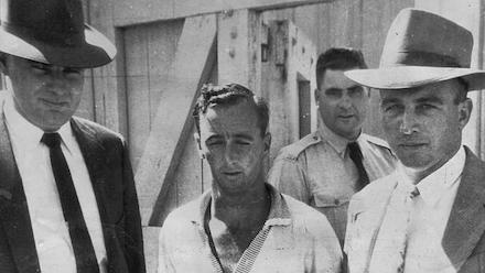 How Raymond John Bailey Was Hanged for the Sundown Murders 4 Raymond John Bailey escorted by detectives following his arrest in Mount Isa, Queensland, January 1958.