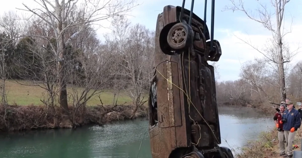 Erin Foster's 1988 Pontiac Grand Am being lifted from the Calfkiller River, Sparta, Tennessee, December 2021, after 21 years submerged.