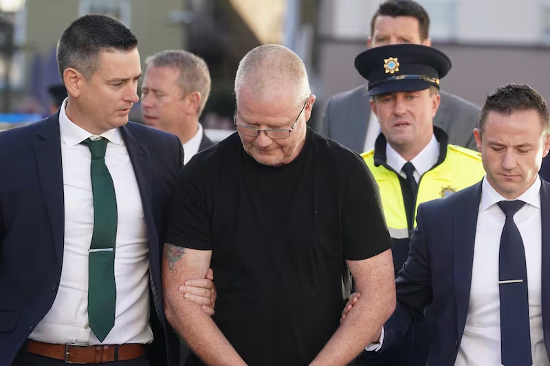 How Richard Satchwell Buried His Wife Beneath the Stairs and Spent Six Years on Television Asking Her to Come Home 6 Richard Satchwell being escorted by Garda detectives in Youghal, County Cork, Ireland, following his arrest on suspicion of murder in October 2023.