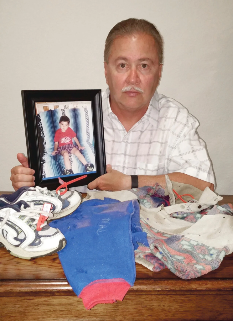 Allyn Atadero holds a photo of his son Jaryd alongside the clothing and sneaker found on the Big South Trail in 2003, four years after Jaryd's disappearance.