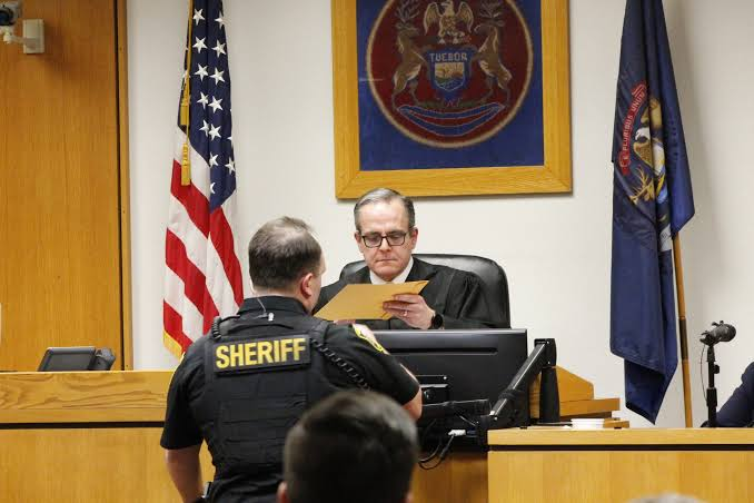 Lenawee County Circuit Judge Michael Olsaver reviews documents during Dale Warner's murder trial in Adrian, Michigan, 2026.