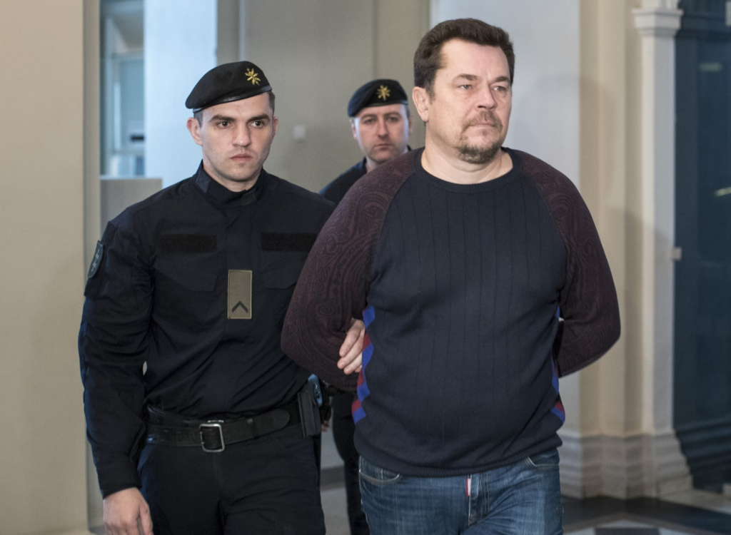 Evaldas Rimasauskas escorted by Lithuanian court officers in Vilnius, May 2017, following his arrest on fraud charges linked to the theft of $122 million from Google and Facebook.