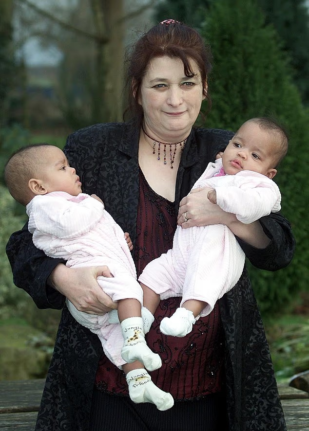 Judith Kilshaw holding twins Kiara and Keyara at the family home in Buckley, North Wales, January 2001. Weeks later, British authorities removed the girls under an emergency protection order and placed them in foster care.