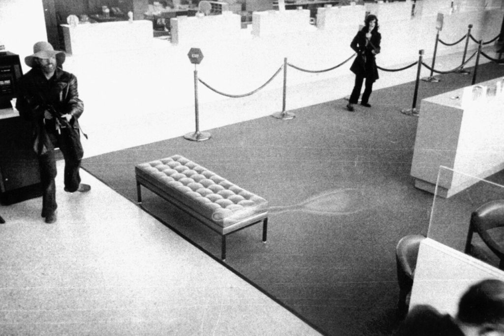 Patty Hearst Went From Kidnapping Victim to Wanted Bank Robber 3 Security camera photo from April 15, 1974, showing Patty Hearst holding a rifle during the SLA's robbery of the Hibernia Bank in San Francisco.