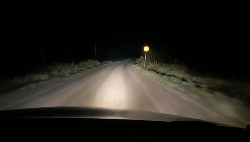 A rural gravel road at night, similar to the back roads Brandon Swanson traveled when he disappeared outside Porter, Minnesota, in May 2008. Searchers estimated he walked several miles through terrain like this in near-freezing darkness before contact was lost.