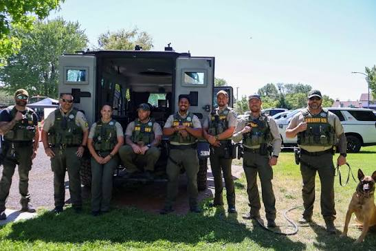 Law enforcement officers and a K9 unit, similar to the search teams deployed across Lyon and Lincoln counties after Brandon Swanson vanished near Porter, Minnesota, in May 2008. Over 40 professionally trained search dogs worked the case across 122 square miles.