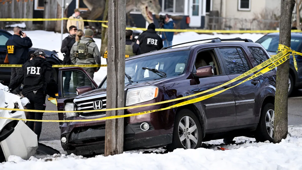 How Oluwadamilola Bamigboye Shouted "Drive" in a Plymouth Parking Lot, Trapped a Federal Agent in a Moving Jeep at Gunpoint, and Ended Up in Federal Court 2 FBI agents examine a dark Honda SUV pinned against a utility pole behind police tape at a winter crime scene.